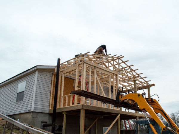 Carpenters on the roof of new building addition